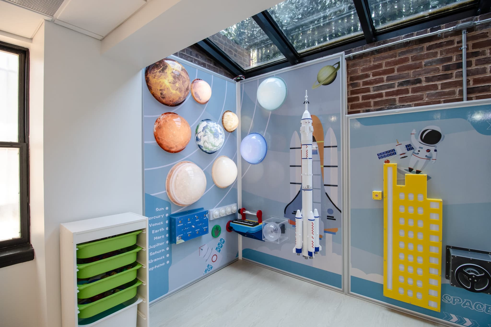 child's-eye view of a space-themed classroom wall with planets and a rocket